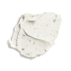 White cream with specks on a white background