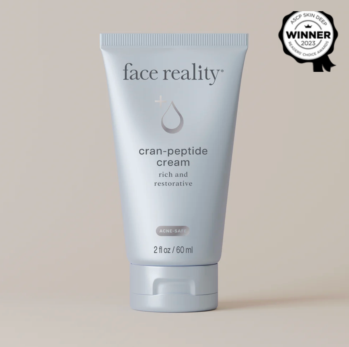 Tube of 'face reality' cran-peptide cream on a beige background