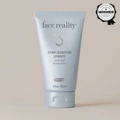 Tube of 'face reality' cran-peptide cream on a beige background