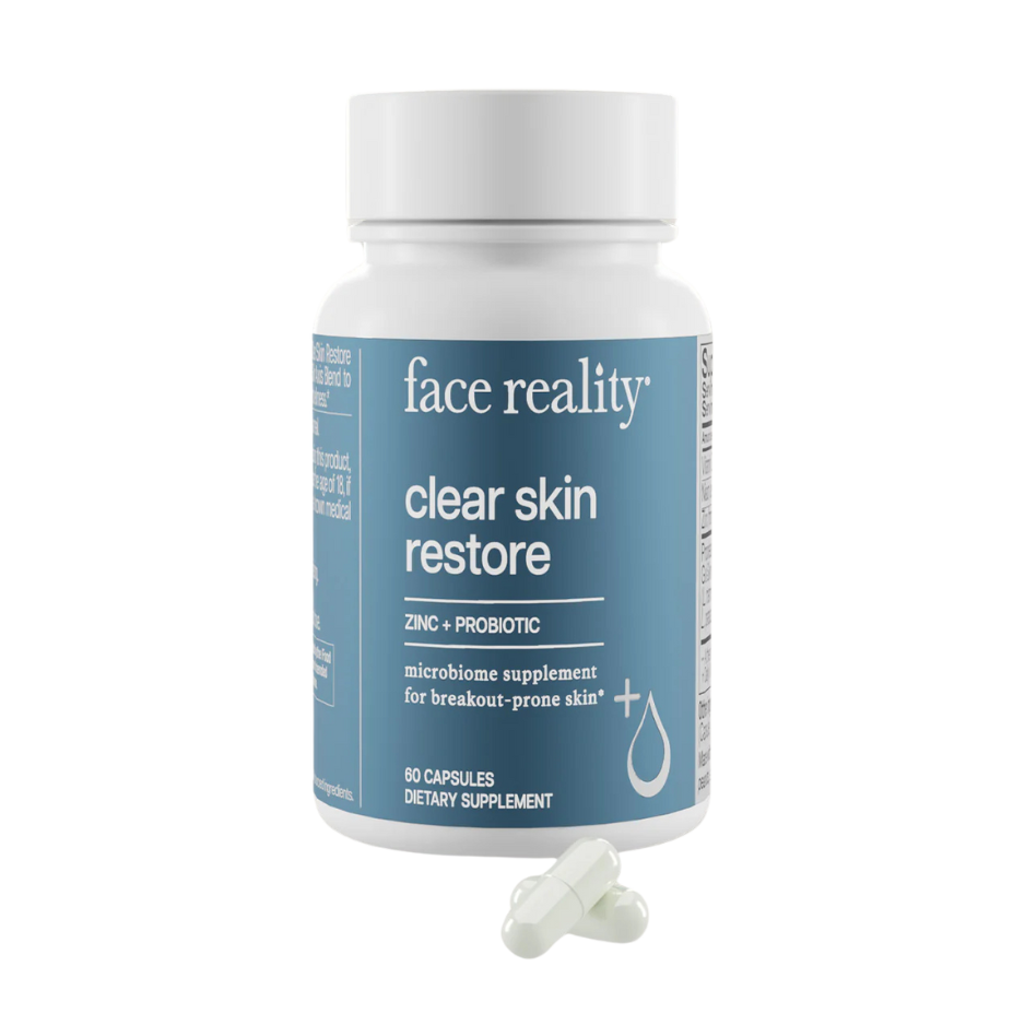 Supplement bottle labeled 'face reality clear skin restore' on a white background
