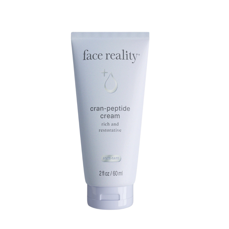 Tube of 'face reality' cran-peptide cream on a white background