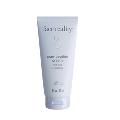 Tube of 'face reality' cran-peptide cream on a white background