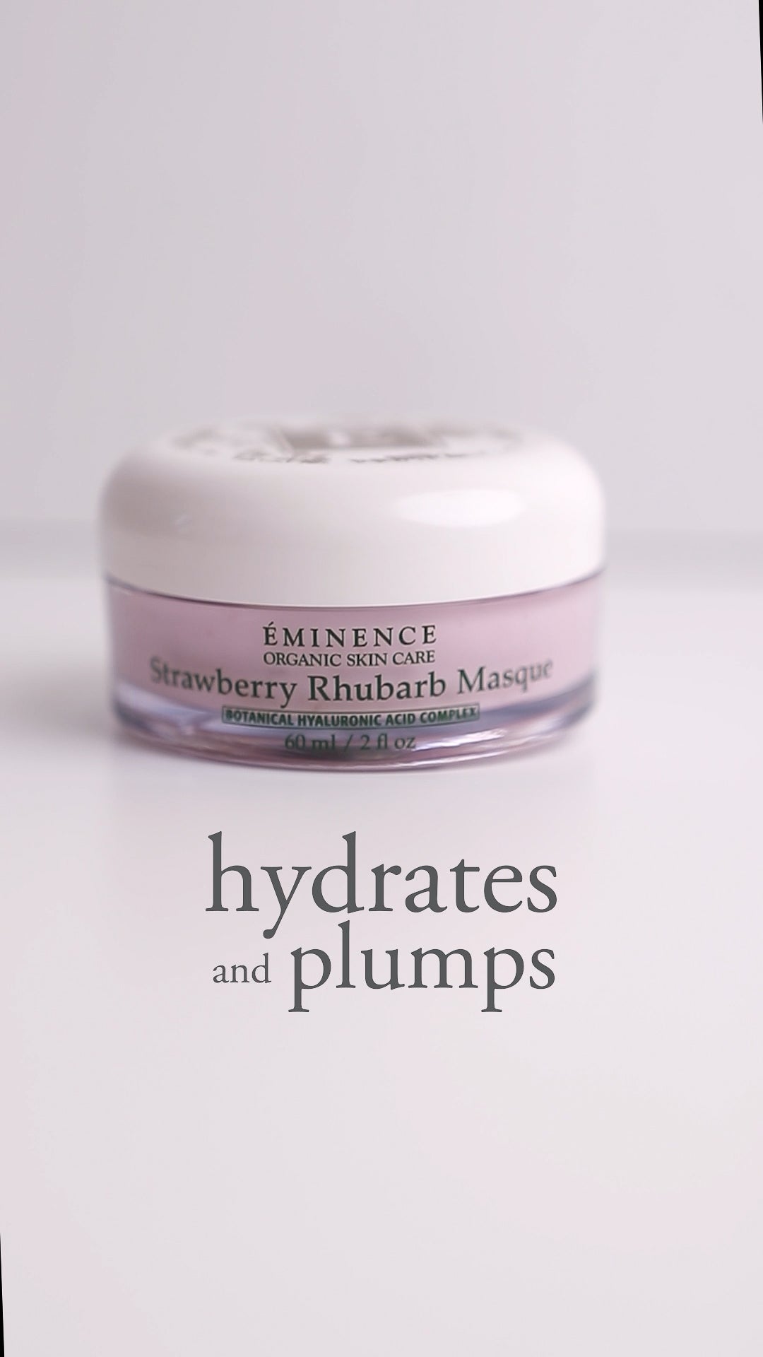 Jar of Eminence Strawberry Rhubarb Masque with text 'hydrates and plumps' on a light background