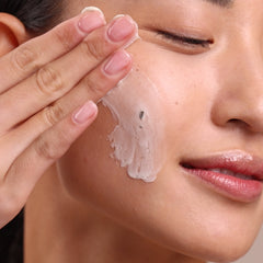 Close-up of a person applying cream to their face
